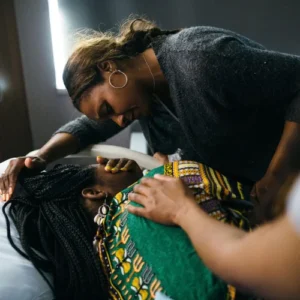 A doula comforts someone in labor.